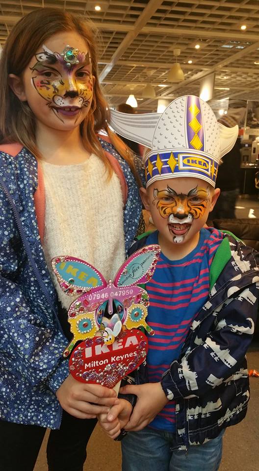 Two children in IKEA after getting their faces painted